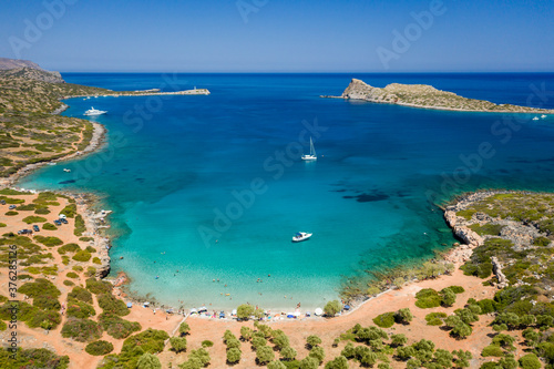 Fototapeta Naklejka Na Ścianę i Meble -  Aerial view of the rugged coastline of Crete and the clear waters of the Aegean Sea (Elounda, Greece)
