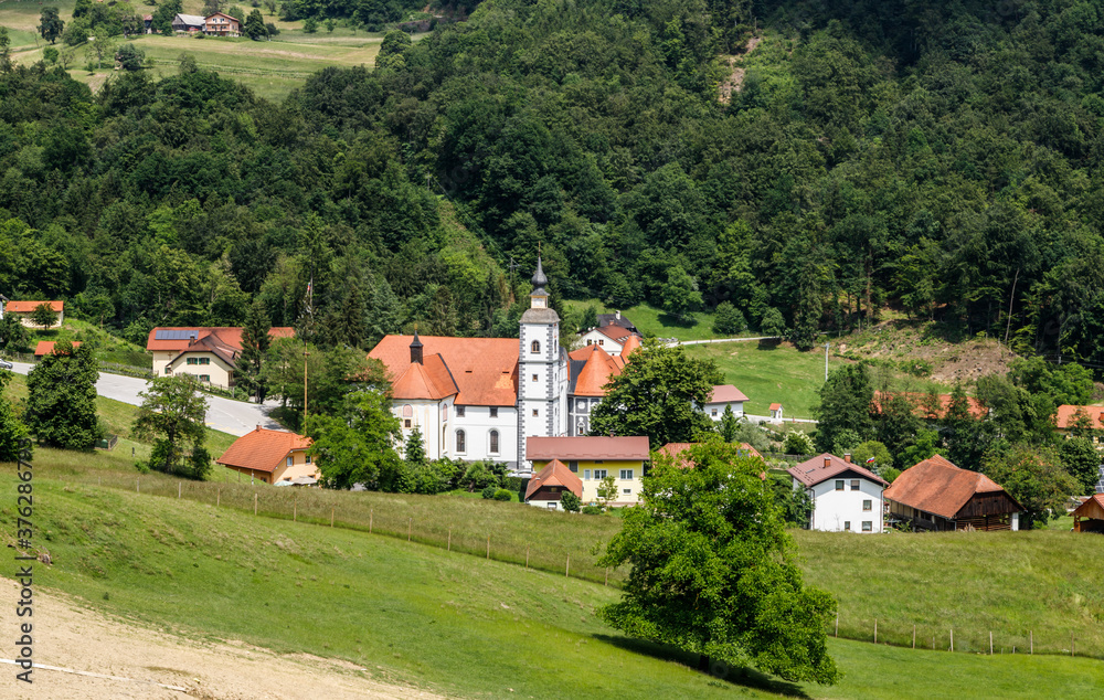 Slovenian landscape. Mountain village in Alps with a nice catholic church in Slovenian countryside.  