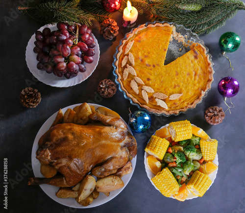 A traditional Thanksgiving dinner setting. Traditional pie and chicken. Thanksgiving Day celebration concept. Christmas or New Year. view from above. photo