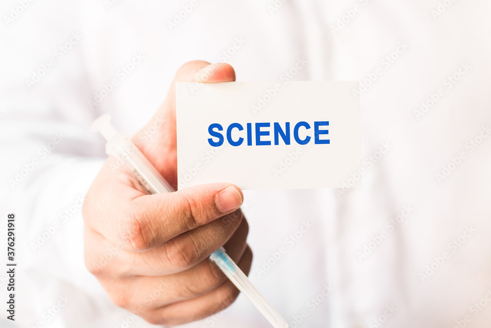 Word science on a white background with a syringe in hand. Medicine concept Word science on a white background with a syringe in hand. Medicine concept