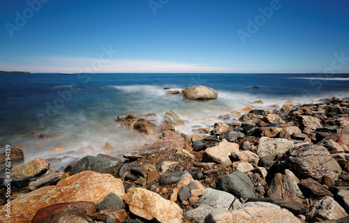 Cuadro en lienzo Rocks and slow motion ocean wave at Rye Harbor State Park, Portsmouth NH, USA