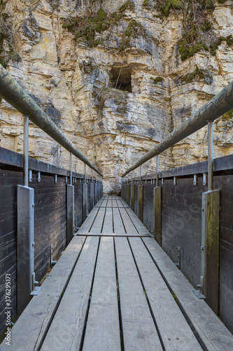 Fototapeta Naklejka Na Ścianę i Meble -  A hike through the Wutach gorge leads over wooden footbridges and narrow paths. The gorge is a special natural spectacle and a unique hiking paradise in southern Germany.