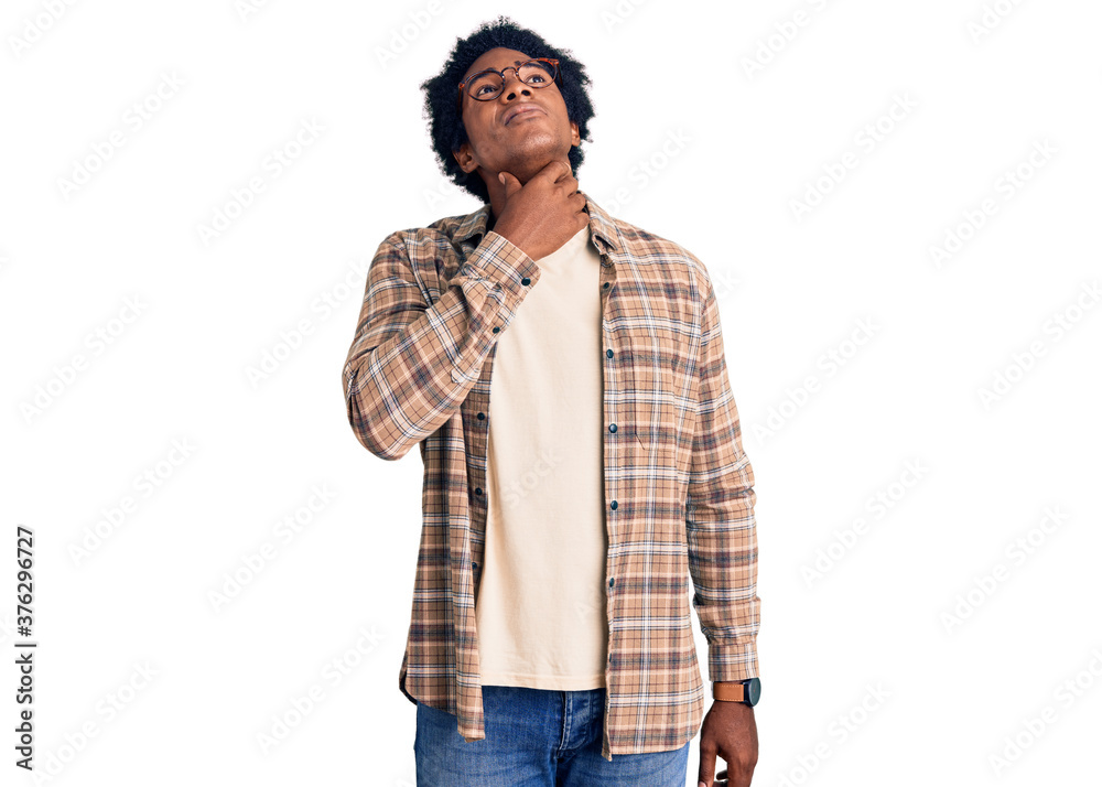 Handsome african american man with afro hair wearing casual clothes and glasses touching painful neck, sore throat for flu, clod and infection Handsome african american man with afro hair wearing casual clothes and glasses touching painful neck, sore throat for flu, clod and infection