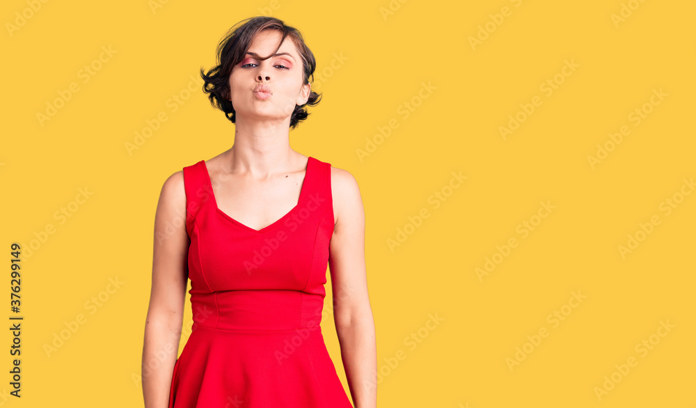 © Krakenimages.com - Beautiful young woman with short hair wearing casual style with sleeveless shirt looking at the camera blowing a kiss on air being lovely and sexy. love expression. © Krakenimages.com - Beautiful young woman with short hair wearing casual style with sleeveless shirt looking at the camera blowing a kiss on air being lovely and sexy. love expression.