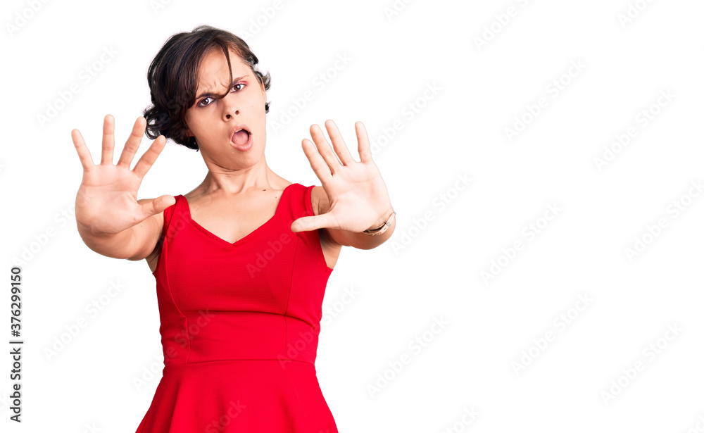 Beautiful young woman with short hair wearing casual style with sleeveless shirt doing stop gesture with hands palms, angry and frustration expression Beautiful young woman with short hair wearing casual style with sleeveless shirt doing stop gesture with hands palms, angry and frustration expression