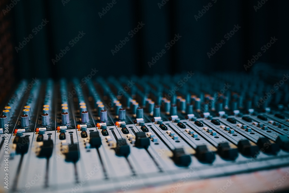 Remote sound engineer. Many buttons of black audio mixer board console for sound producer. Music equipment. Close-up Remote sound engineer. Many buttons of black audio mixer board console for sound producer. Music equipment. Close-up