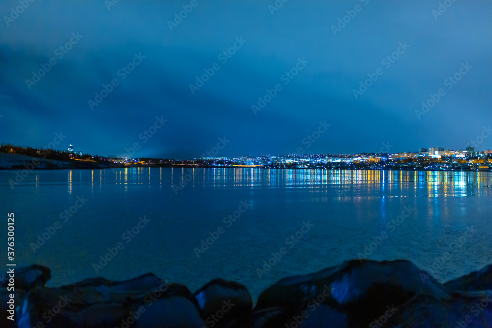 Fototapeta premium Night photo of Reykjavik city beach. Waterfront lights
