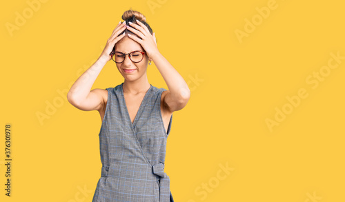 Fotografie Beautiful caucasian woman with blonde hair wearing business clothes and glasses suffering from headache desperate and stressed because pain and migraine