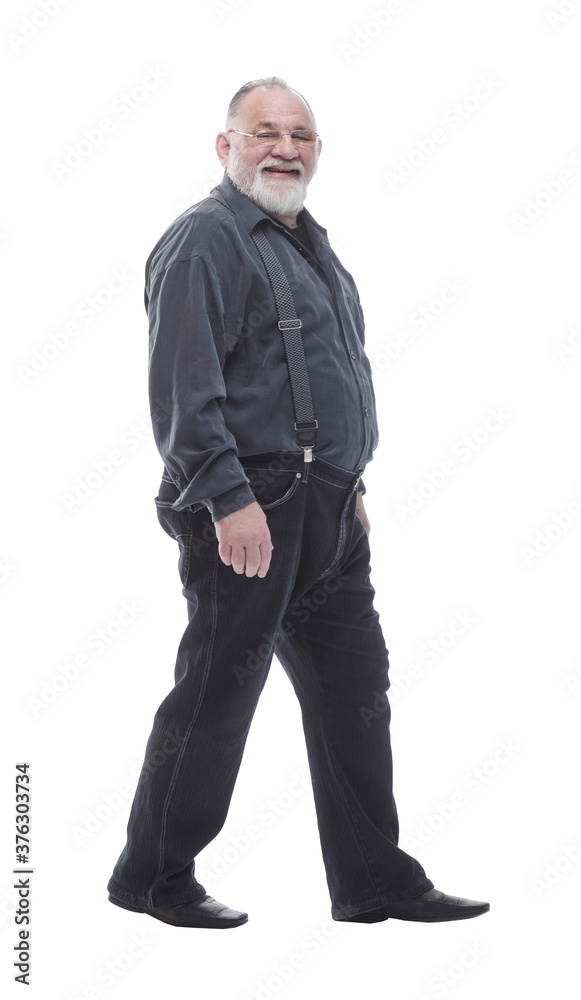 in full growth. happy bearded man striding forward. in full growth. happy bearded man striding forward.