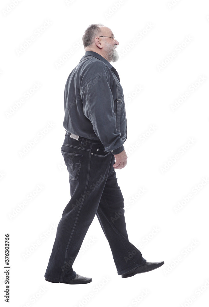 in full growth. happy bearded man striding forward. in full growth. happy bearded man striding forward.