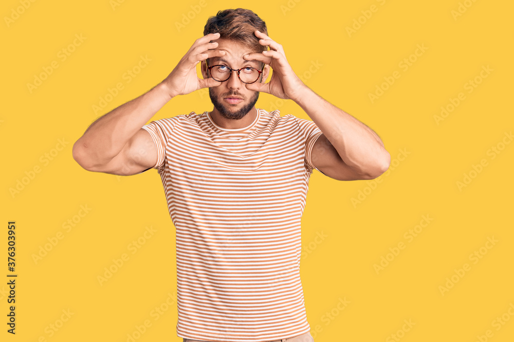 Young caucasian man wearing casual clothes and glasses trying to open eyes with fingers, sleepy and tired for morning fatigue Young caucasian man wearing casual clothes and glasses trying to open eyes with fingers, sleepy and tired for morning fatigue