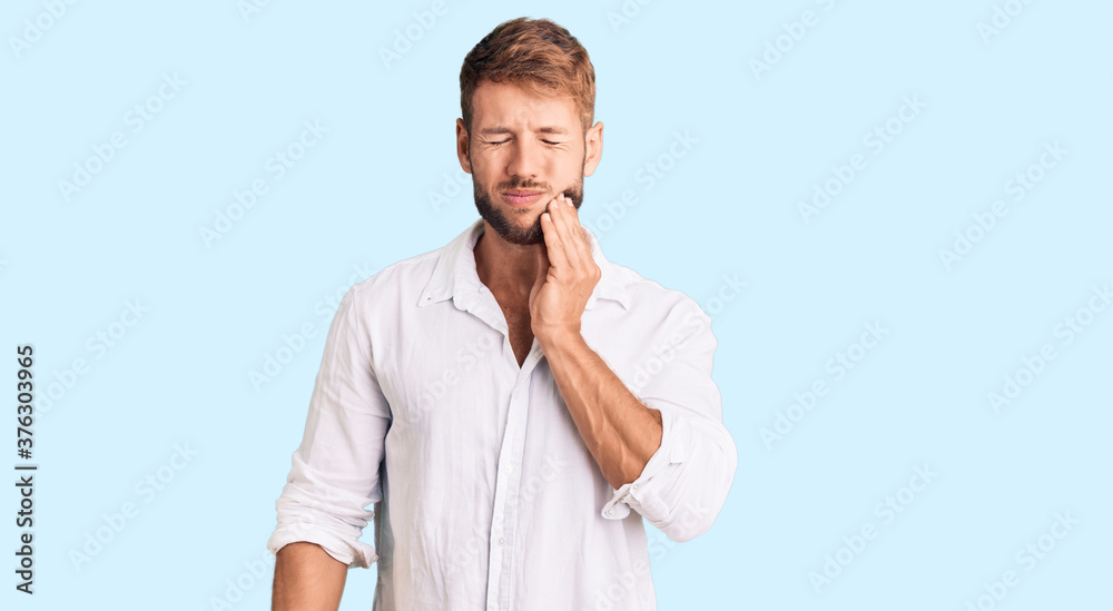 Young caucasian man wearing casual clothes touching mouth with hand with painful expression because of toothache or dental illness on teeth. dentist Young caucasian man wearing casual clothes touching mouth with hand with painful expression because of toothache or dental illness on teeth. dentist