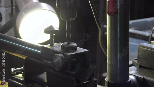 Close-up footage of a engineer working with metal drill photo