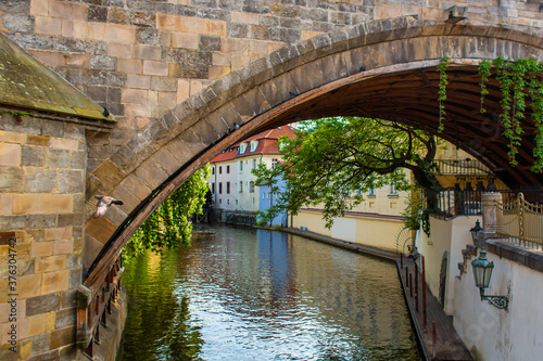 The architecture of the strago city of Prague. River channel in the city. Streets of old Europe, cityscape