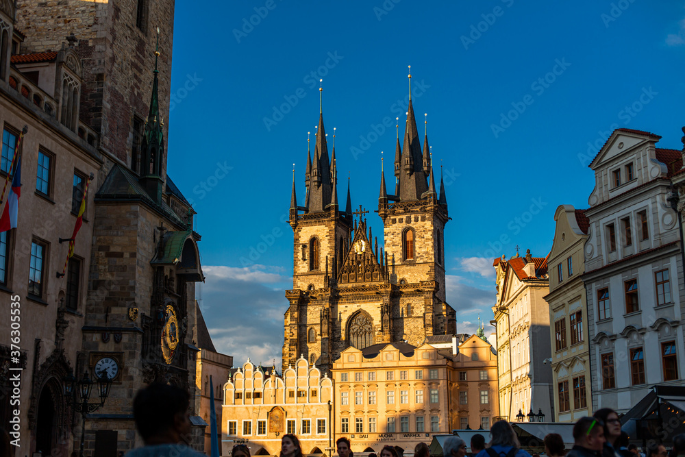 Tyn Temple on the Old Town Square in Prague. A crowd of tourists walk on the Old Town Square in Prague