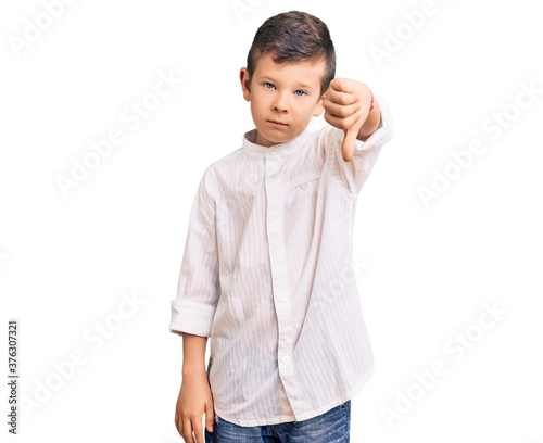 Cute blond kid wearing elegant shirt looking unhappy and angry showing rejection and negative with thumbs down gesture. bad expression.