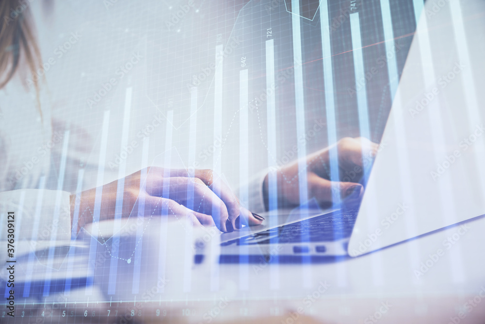 Double exposure of woman hands working on computer and forex graph hologram drawing. Financial analysis concept. Double exposure of woman hands working on computer and forex graph hologram drawing. Financial analysis concept.
