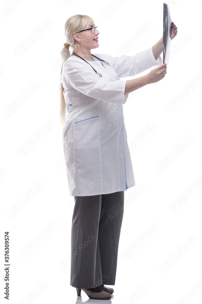smiling woman doctor looking at an x- ray. isolated on a white smiling woman doctor looking at an x- ray. isolated on a white