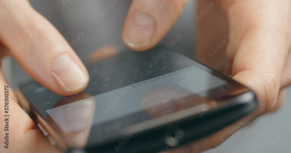 Closeup handheld shot of a woman typing a text message on a smartphone. Closeup handheld shot of a woman typing a text message on a smartphone.