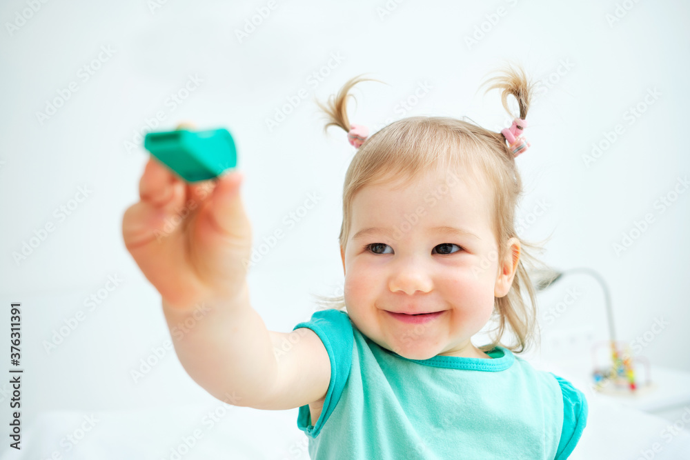 Caucasian kid smiling and showing toy whistle Caucasian kid smiling and showing toy whistle
