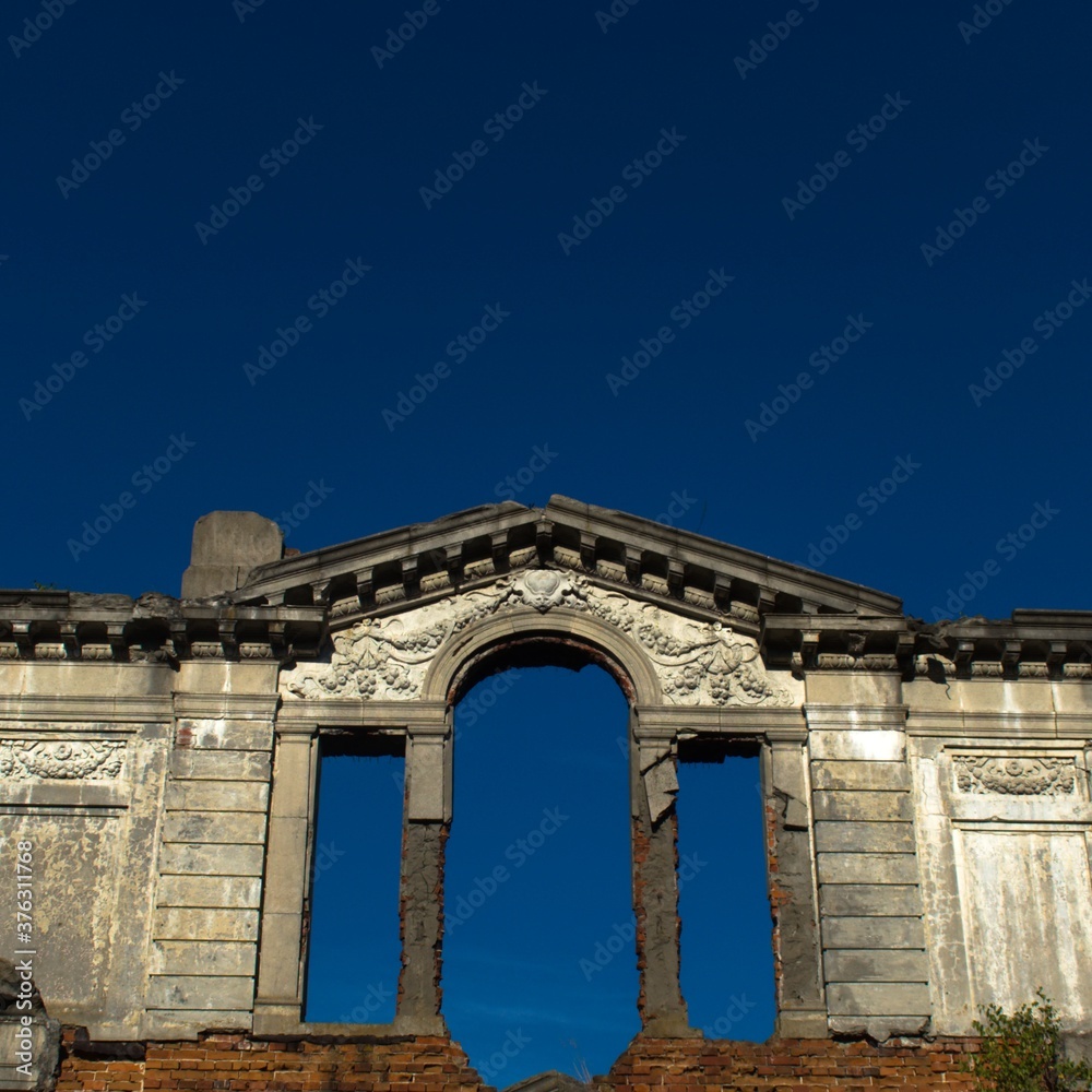 ruined wall of old palace on blue sky background