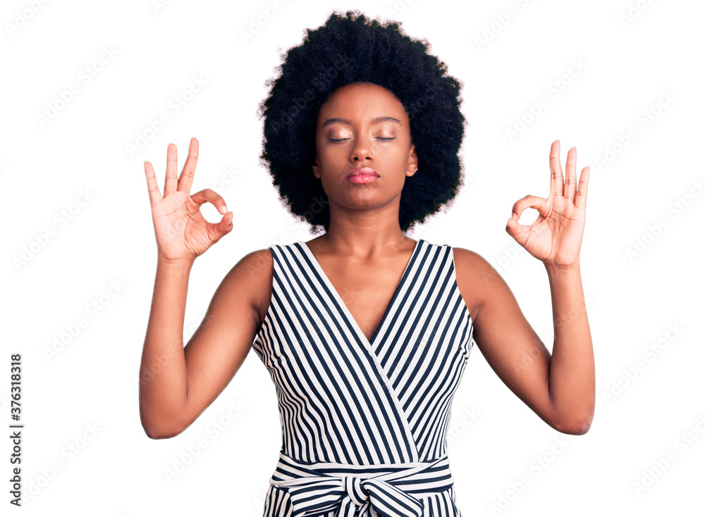 Young african american woman wearing casual clothes relax and smiling with eyes closed doing meditation gesture with fingers. yoga concept. Young african american woman wearing casual clothes relax and smiling with eyes closed doing meditation gesture with fingers. yoga concept.