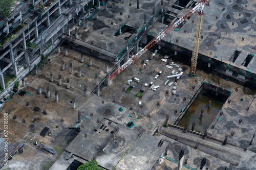 Top view of the construction site of a large building after rain. Piles are driven in and the lower floors are built. © Kate