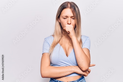 Young blonde woman wearing casual clothes feeling unwell and coughing as symptom for cold or bronchitis. health care concept.