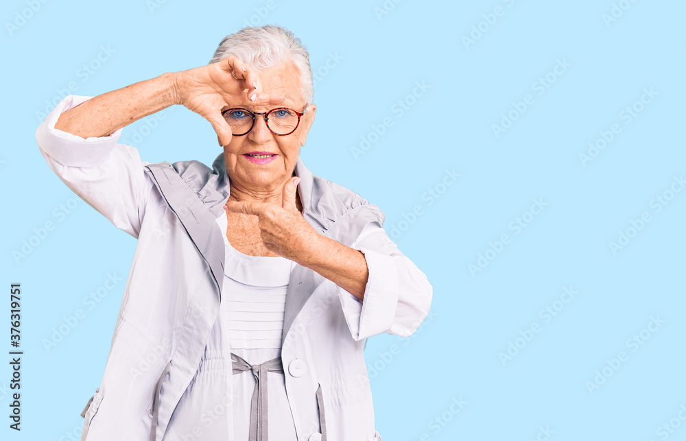 Senior beautiful woman with blue eyes and grey hair wearing casual clothes and glasses smiling making frame with hands and fingers with happy face. creativity and photography concept. Senior beautiful woman with blue eyes and grey hair wearing casual clothes and glasses smiling making frame with hands and fingers with happy face. creativity and photography concept.