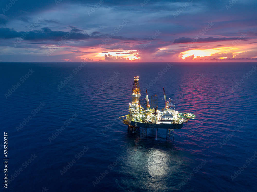Aerial view from a drone of an offshore jack up rig at the offshore location during twilight time