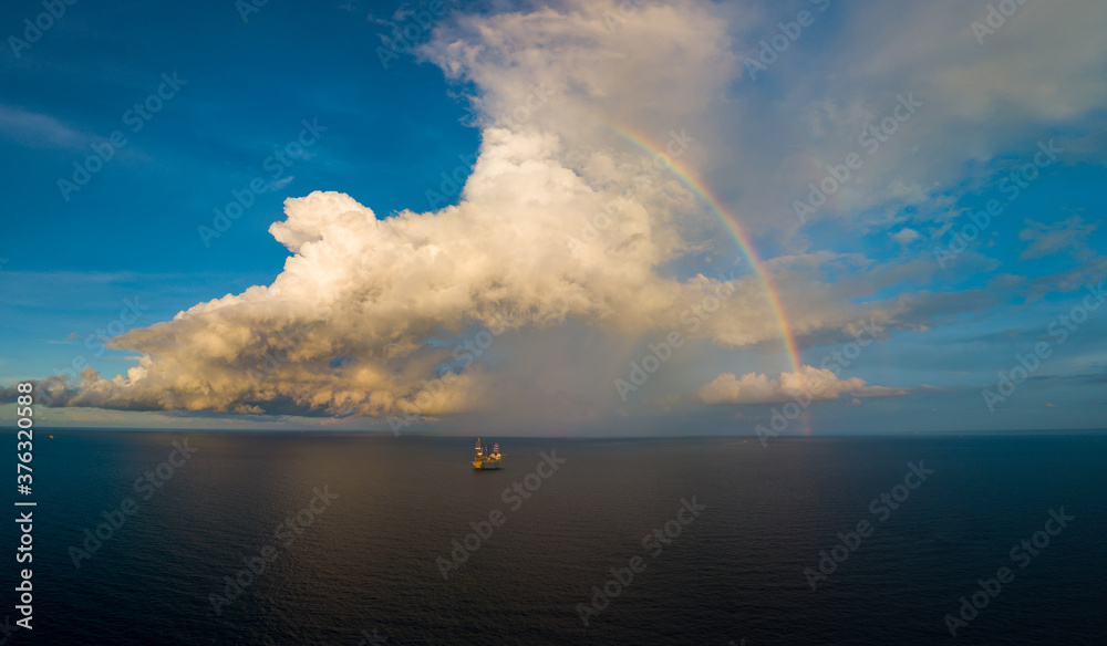 Aerial panorama view from a drone of an offshore jack up rig with beautiful sky and rainbow  at the offshore location