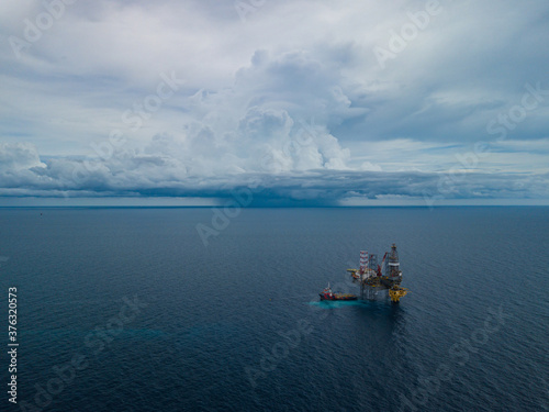 Aerial view from a drone of an offshore jack up rig at the offshore location during raining time © bomboman