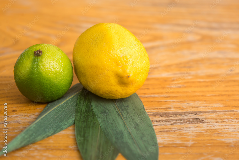 Lemon and lime lie on a wooden stand