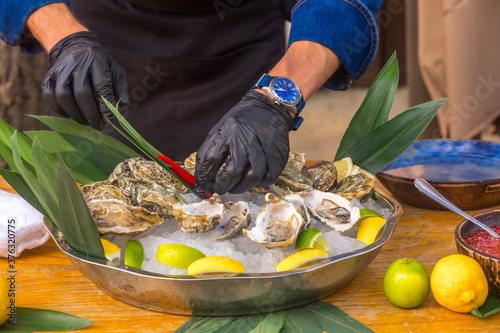 Chef prepares oysters outdoors