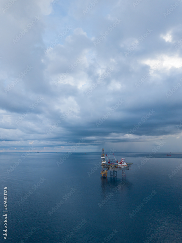 Aerial view from a drone of an offshore jack up rig at the offshore location during raining time