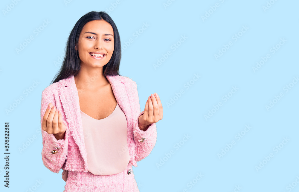 Young beautiful latin girl wearing business clothes doing money gesture with hands, asking for salary payment, millionaire business Young beautiful latin girl wearing business clothes doing money gesture with hands, asking for salary payment, millionaire business