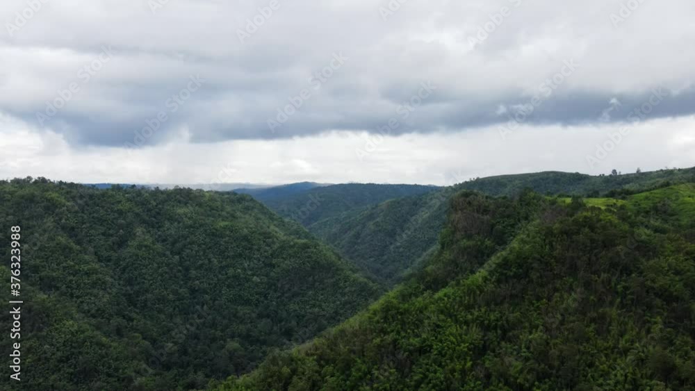 Bird's eye view Zoom out, the countryside flying at valley beautiful green mountain landscape, aerial view drone shot.
