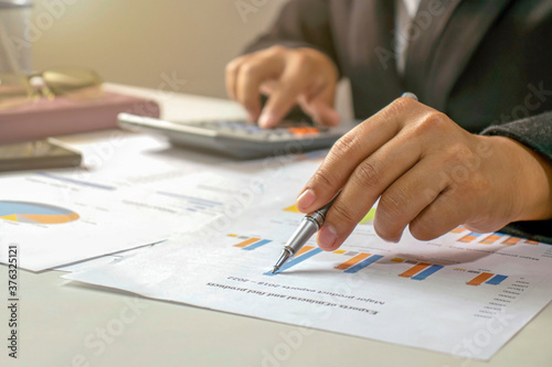 Businessmen are reviewing reports, financial documents for financial data analysis, work ideas and market data.