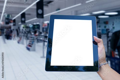 Mock up Tablet in hand closeup on airport background. Concept on the theme of air travel.