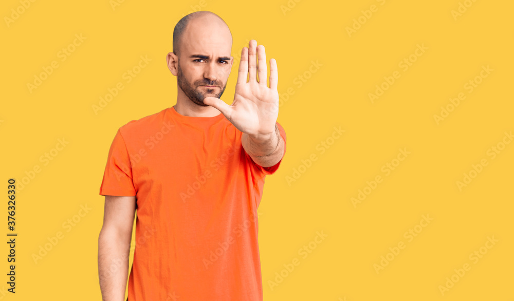 Young handsome man wering casual t shirt doing stop sing with palm of the hand. warning expression with negative and serious gesture on the face. Young handsome man wering casual t shirt doing stop sing with palm of the hand. warning expression with negative and serious gesture on the face.