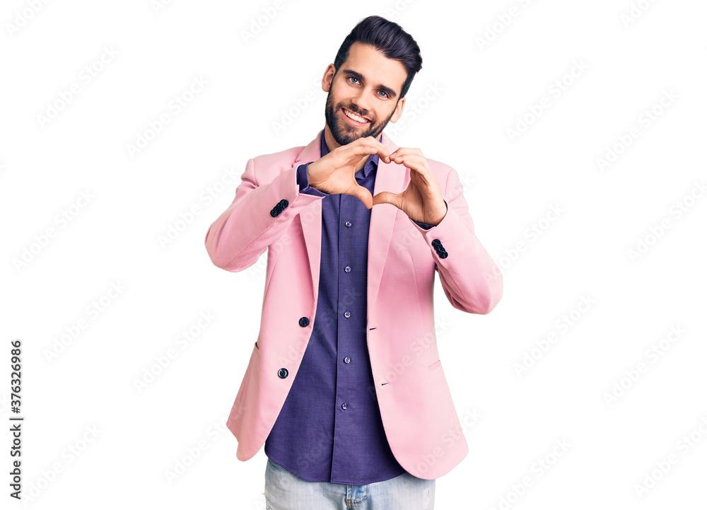 Young handsome man with beard wearing elegant jacket smiling in love showing heart symbol and shape with hands. romantic concept. Young handsome man with beard wearing elegant jacket smiling in love showing heart symbol and shape with hands. romantic concept.