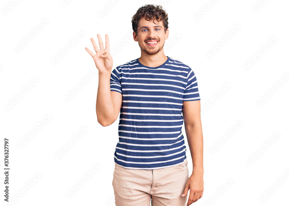 Young handsome man with curly hair wearing casual clothes showing and pointing up with fingers number four while smiling confident and happy. Young handsome man with curly hair wearing casual clothes showing and pointing up with fingers number four while smiling confident and happy.