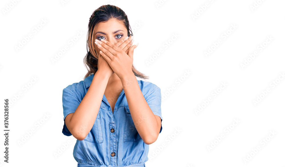 Young beautiful woman wearing casual clothes shocked covering mouth with hands for mistake. secret concept. Young beautiful woman wearing casual clothes shocked covering mouth with hands for mistake. secret concept.