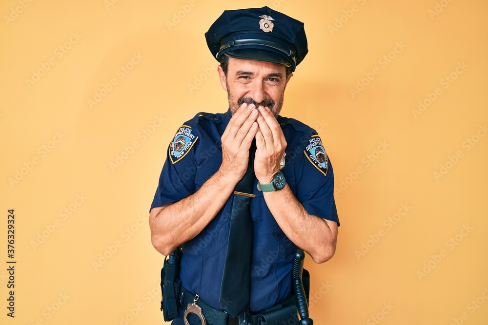 Middle age hispanic man wearing police uniform laughing and embarrassed giggle covering mouth with hands, gossip and scandal concept Middle age hispanic man wearing police uniform laughing and embarrassed giggle covering mouth with hands, gossip and scandal concept
