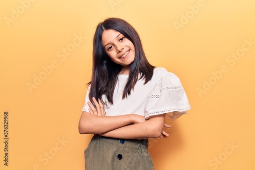 Beautiful child girl wearing casual clothes happy face smiling with crossed arms looking at the camera. positive person.