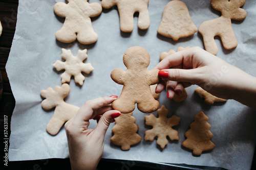 Woman with baked homemade gingerbread cookies