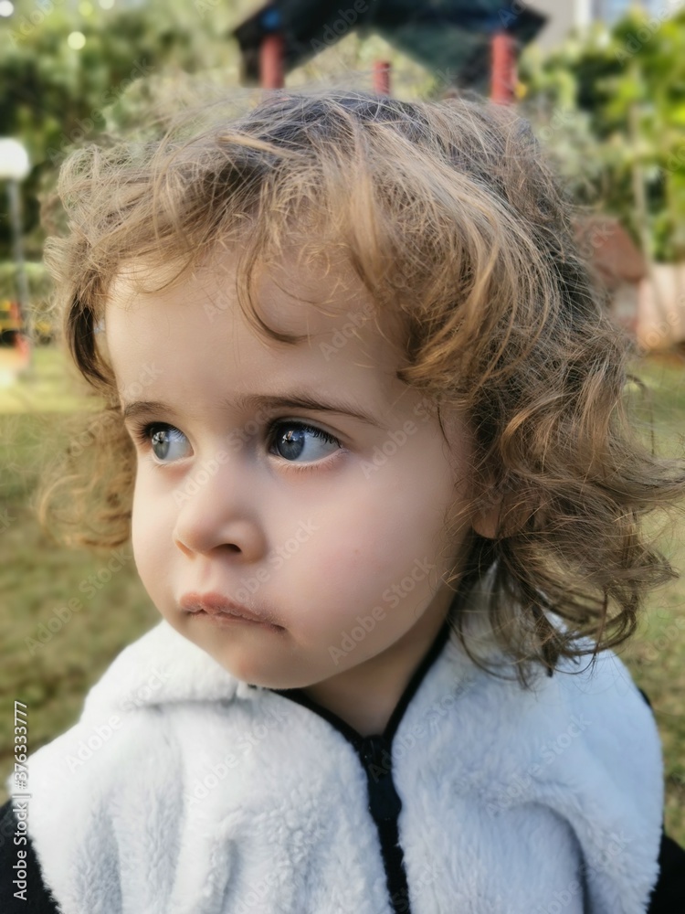 Little Brazilian girl looking to the side outdoors Little Brazilian girl looking to the side outdoors