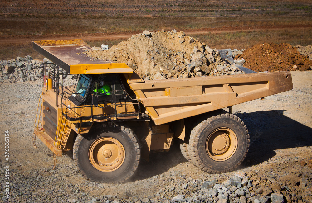Obraz premium Large yellow truck used in modern Mine in Western Australia. Truck transports ore from the open cast mine.