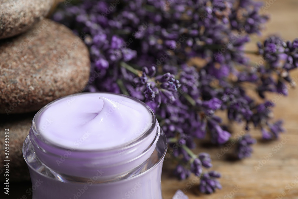 Stones, jar of cream and lavender flowers on table, closeup Stones, jar of cream and lavender flowers on table, closeup