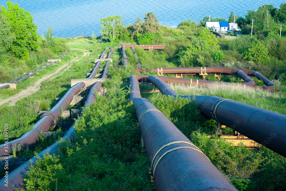 sewer pipes on a hillside draining waste into the river sewer pipes on a hillside draining waste into the river